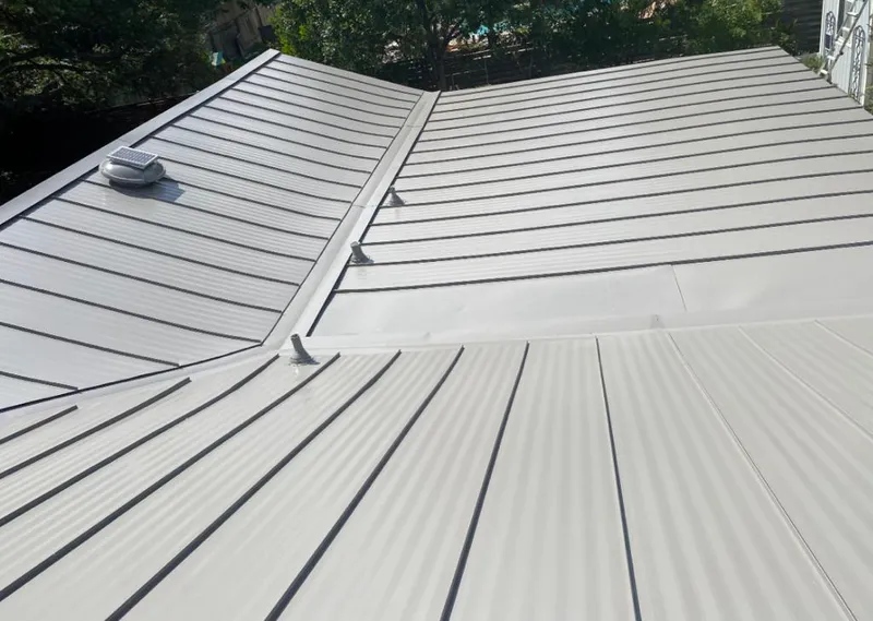 Solar attic fan installed on a metal roof for Roof Ventilation in Kiryas Joel
